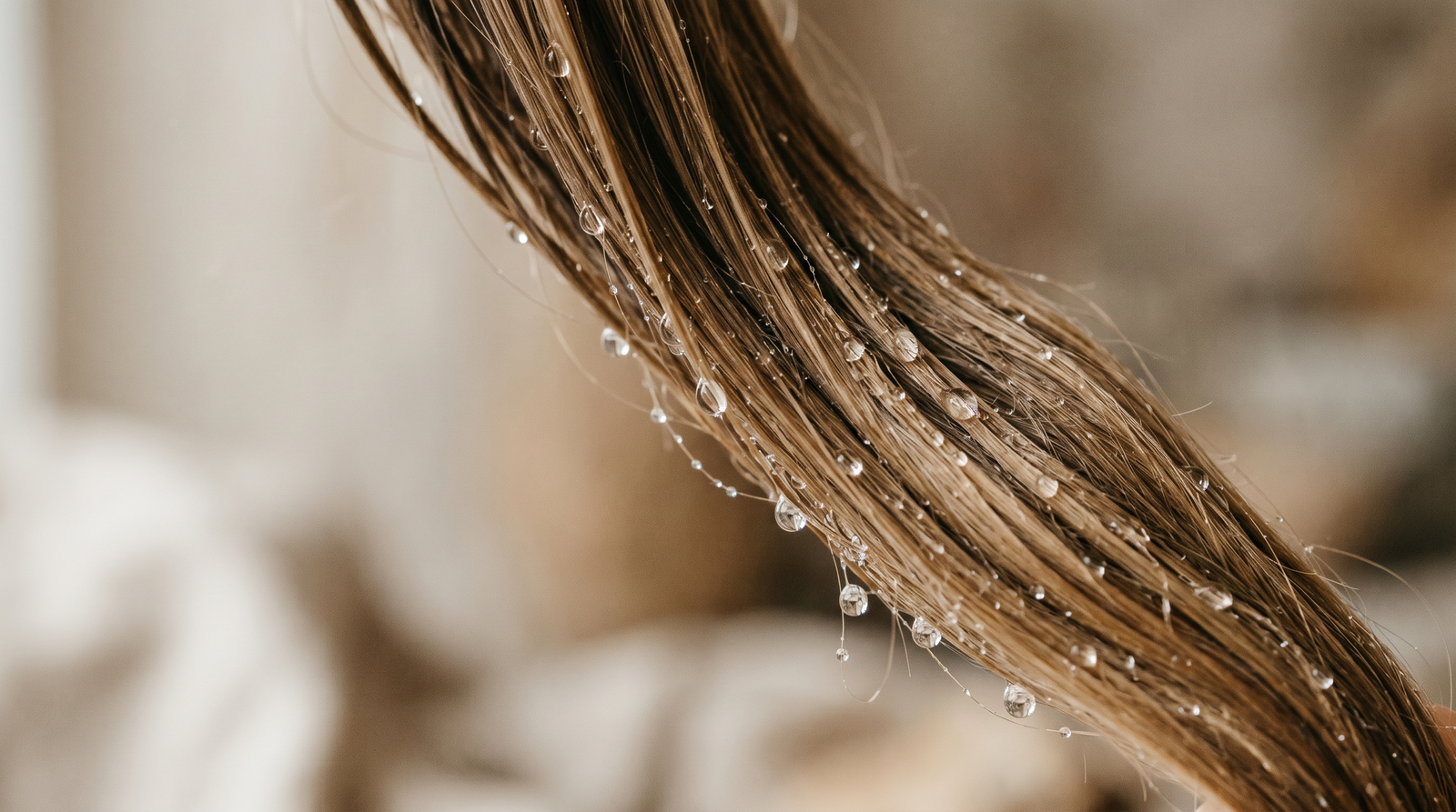 Clean water droplets running over smooth hair
